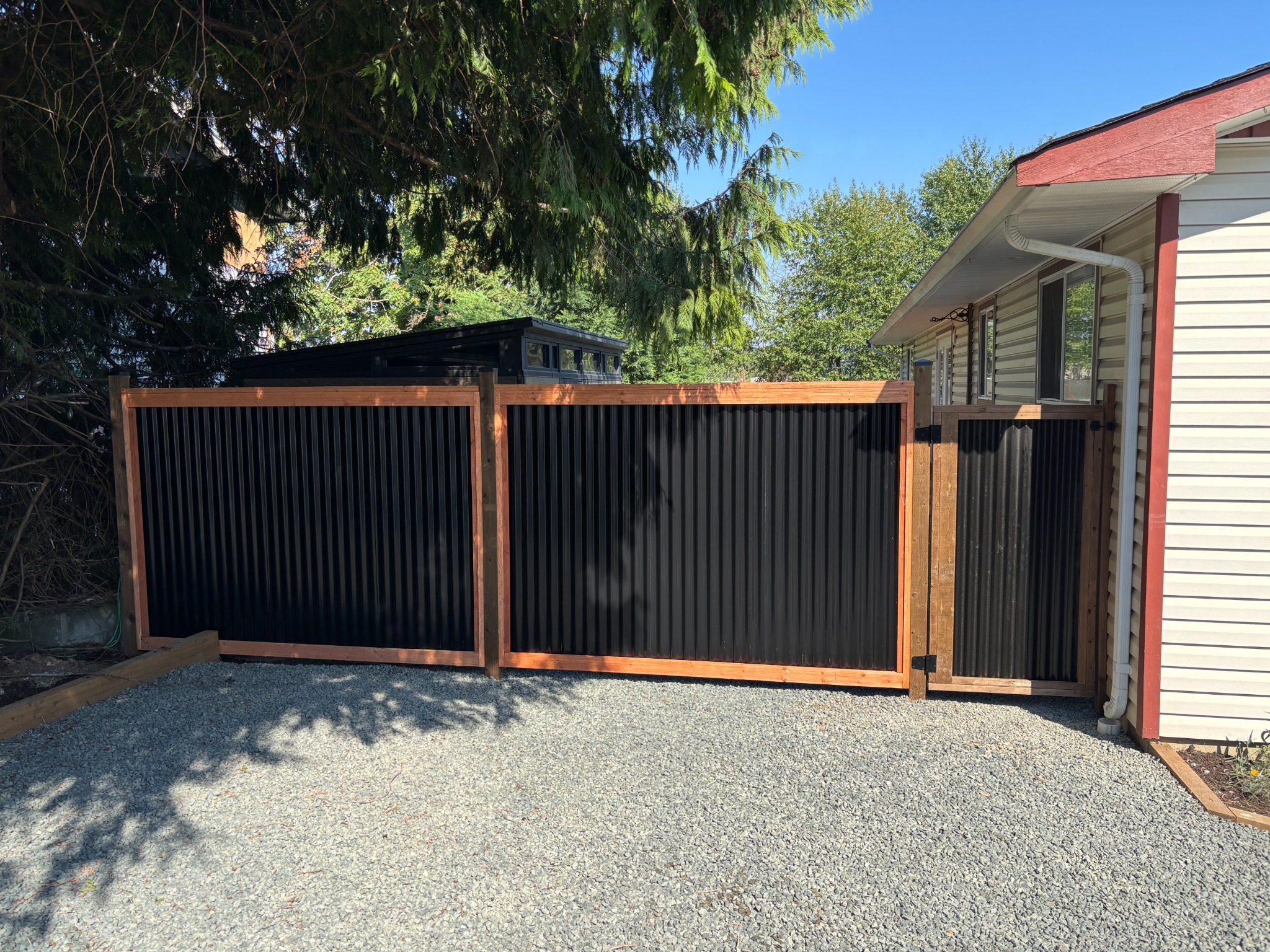 Black corrugated metal and cedar driveway gate